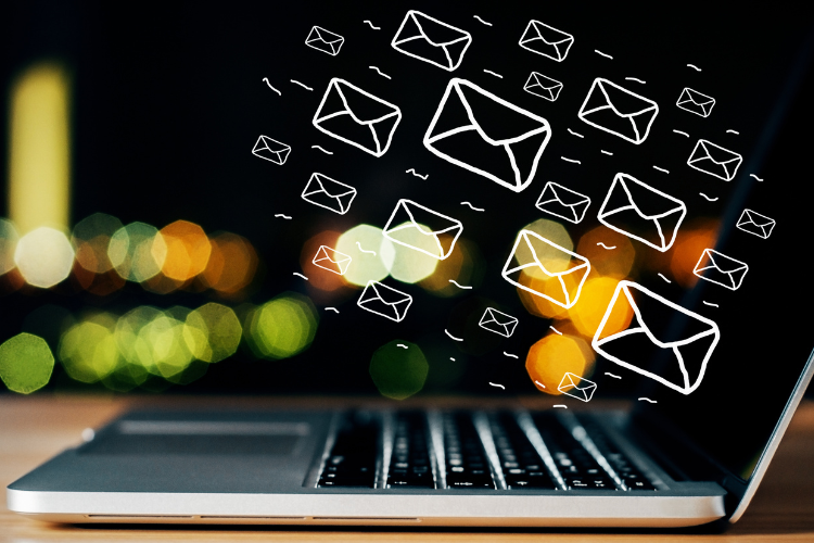 emails flowing out of a laptop for email marketing campaigns