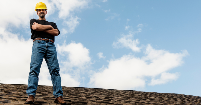 image of a roofing contractor atop of a home